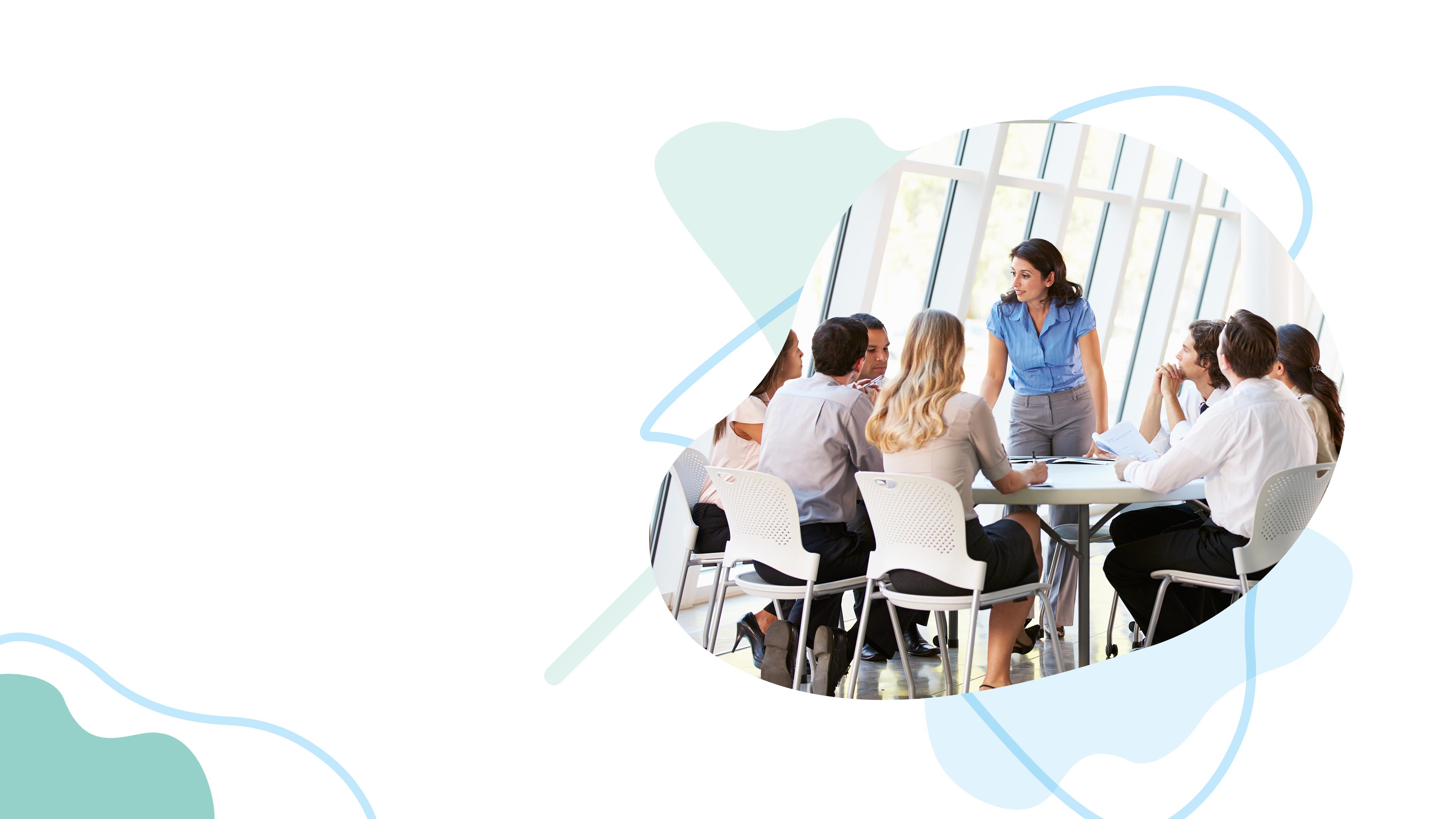 A team gathered around a table in a bright modern meeting room